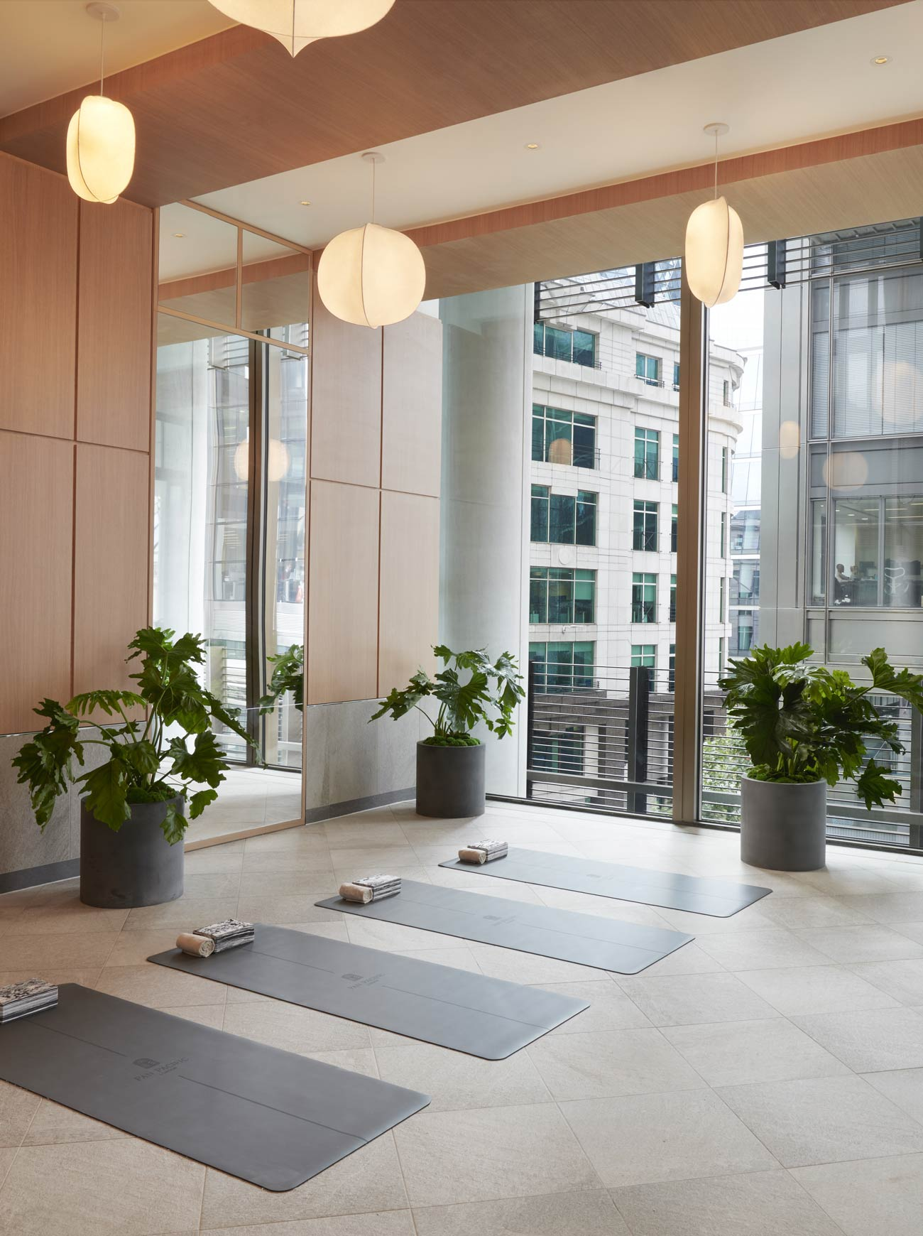 A light-filled yoga studio with floor-to-ceiling windows