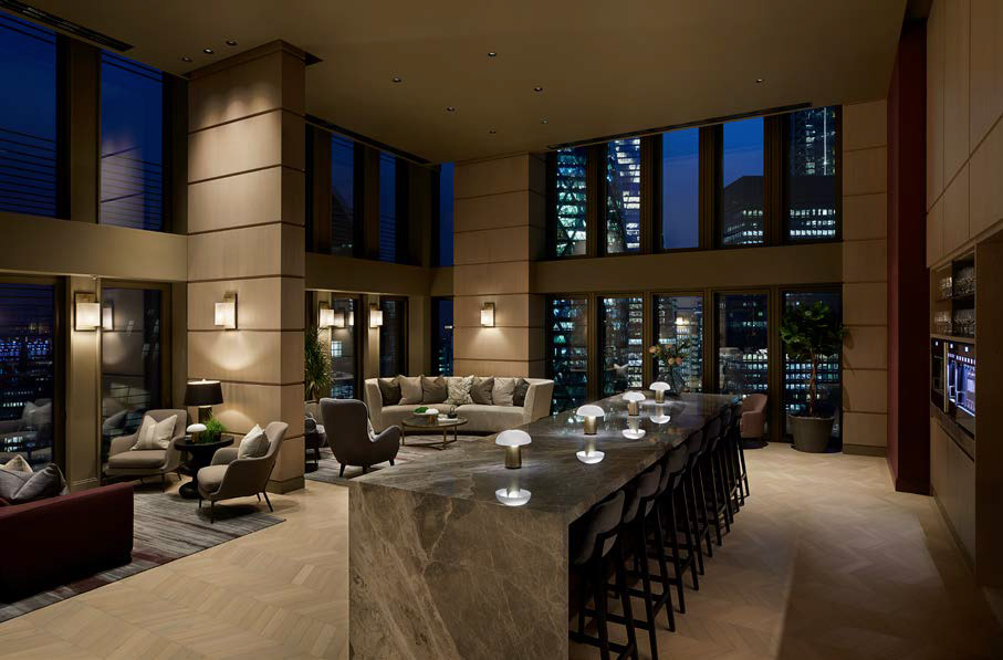 The double-height residents’ lounge at night