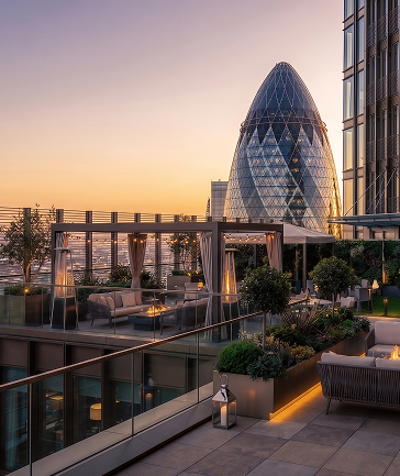 The residents’ sky terrace at sunset with views towards The Gherkin