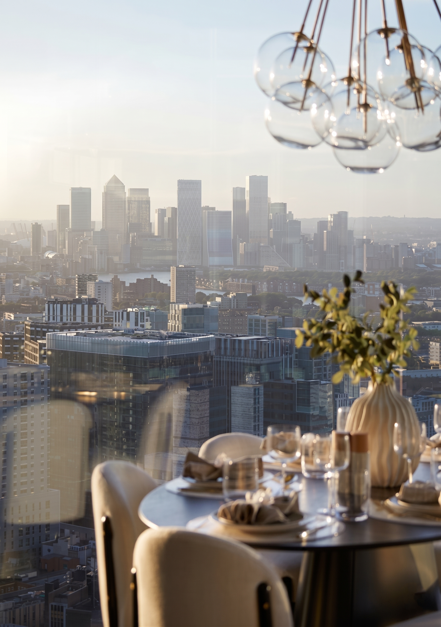 Sky residence dining room with views across the City towards Canary Wharf