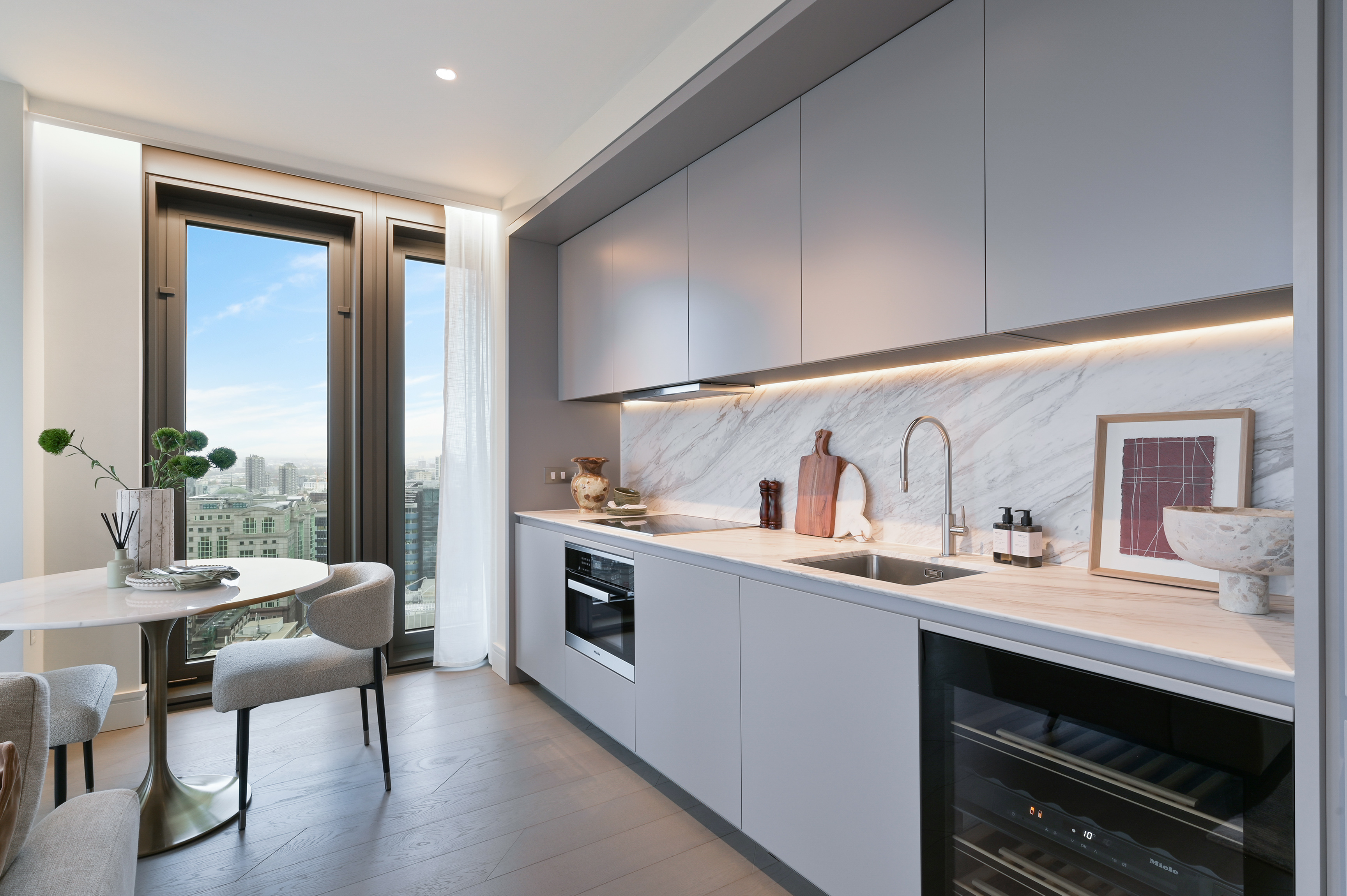 A Sky Residence kitchen with marble splashback and City views